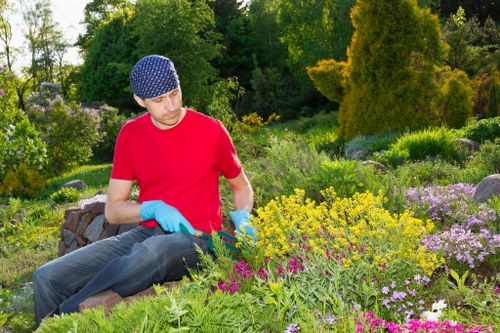 Safety signage and high-visibility clothing at a garden worksite